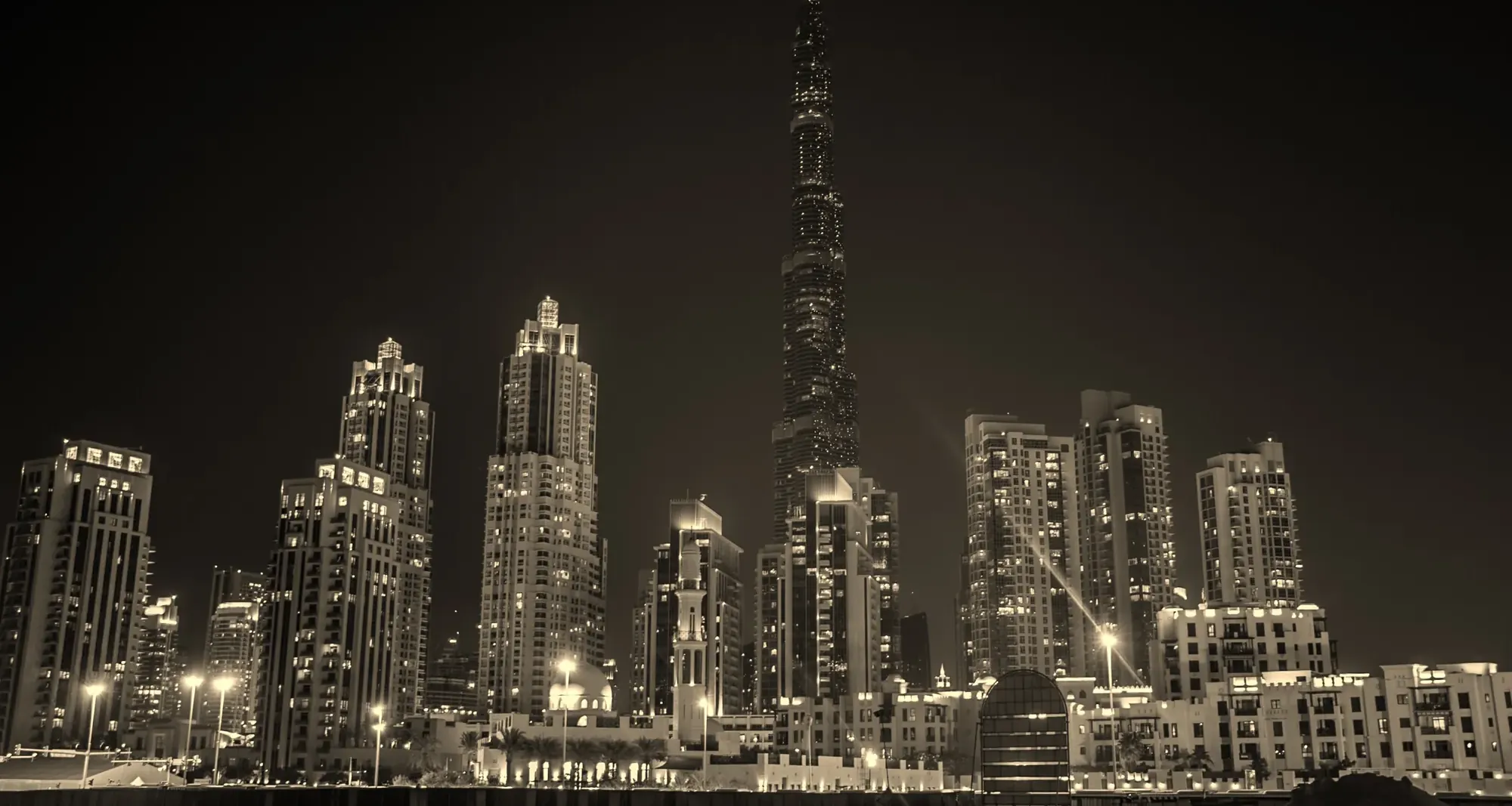Downtown Dubai at dusk, the towers of Business Bay behind the water