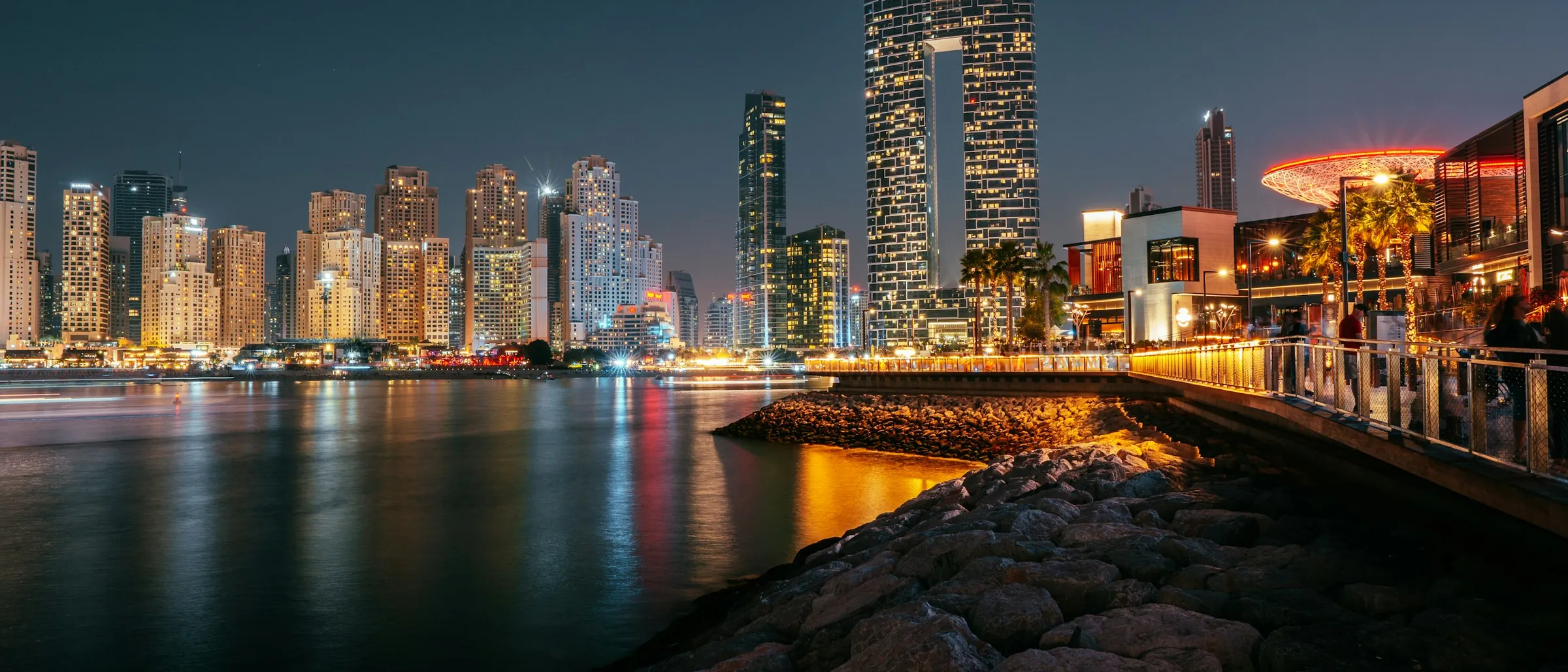 The Dubai waterfront at night, the district lit along the shore