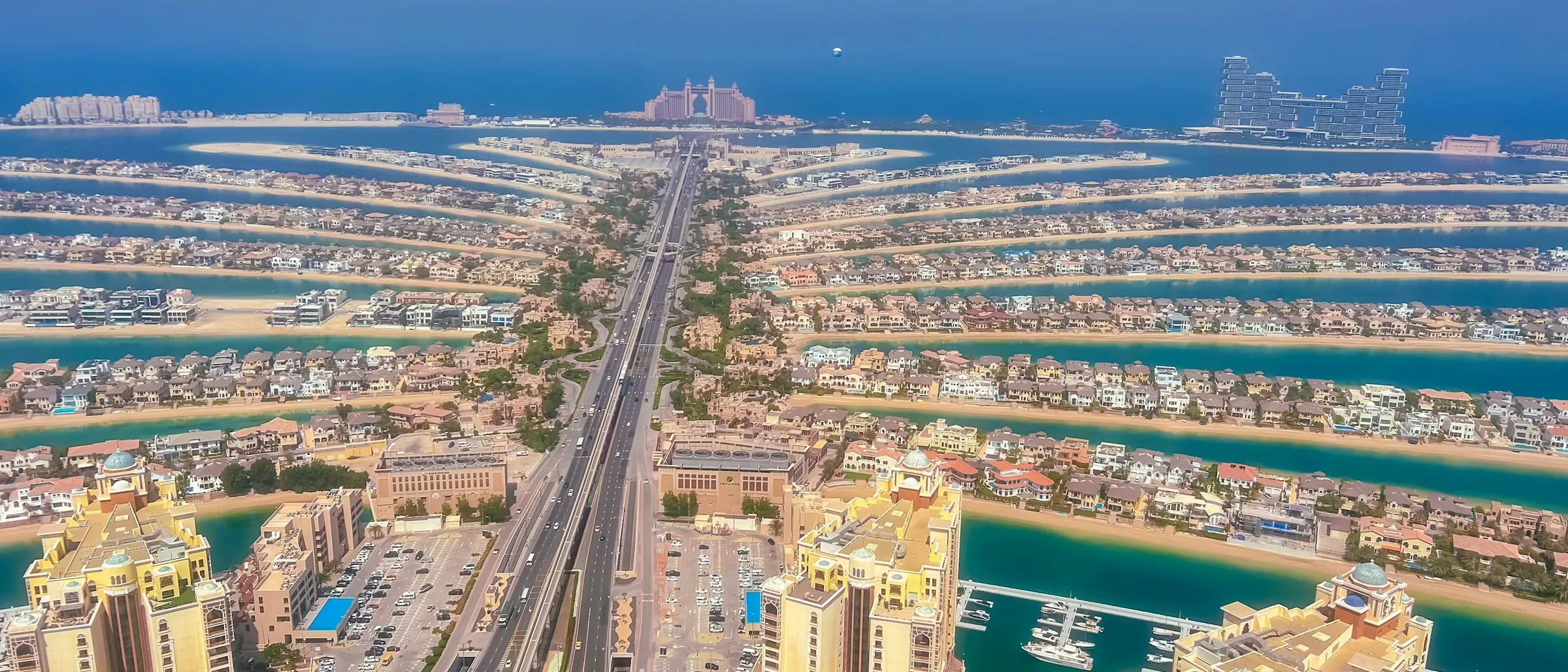 An aerial view of Dubai's coastline and the towers behind it